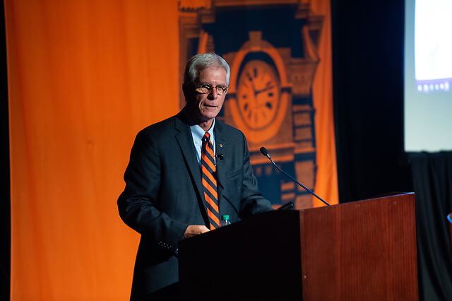 Dean Gregg E. Newschwander speaking at an event.