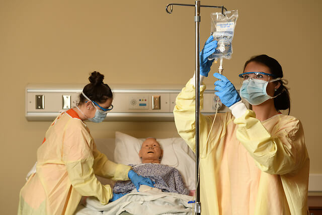 Two students simulating an operation.