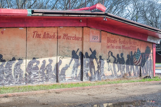 mural in Selma, Alabama: silhouette figures, flag, text "The Attack on Marchers - 109 - Bloody Sunday Began in this area March 7, 1965."
