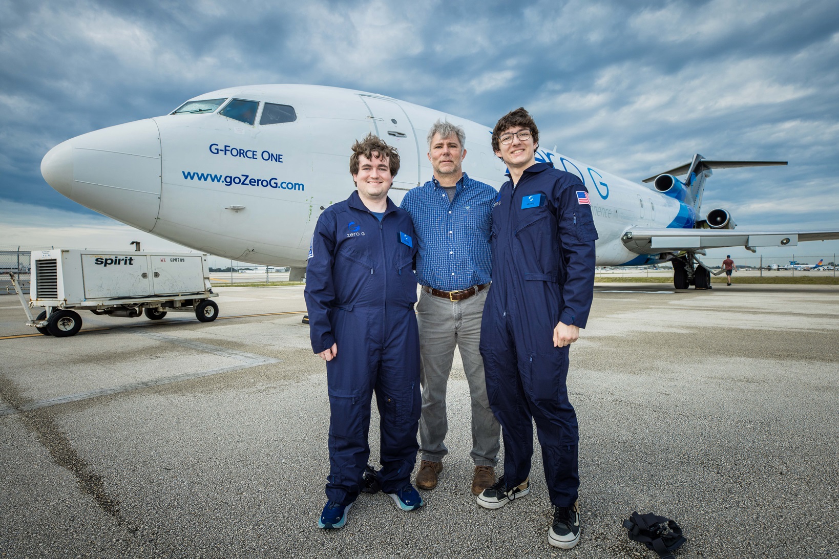 Daniel Stubbs, David Scarborough and Trevor Crane in front of "Vomit Comet" plane