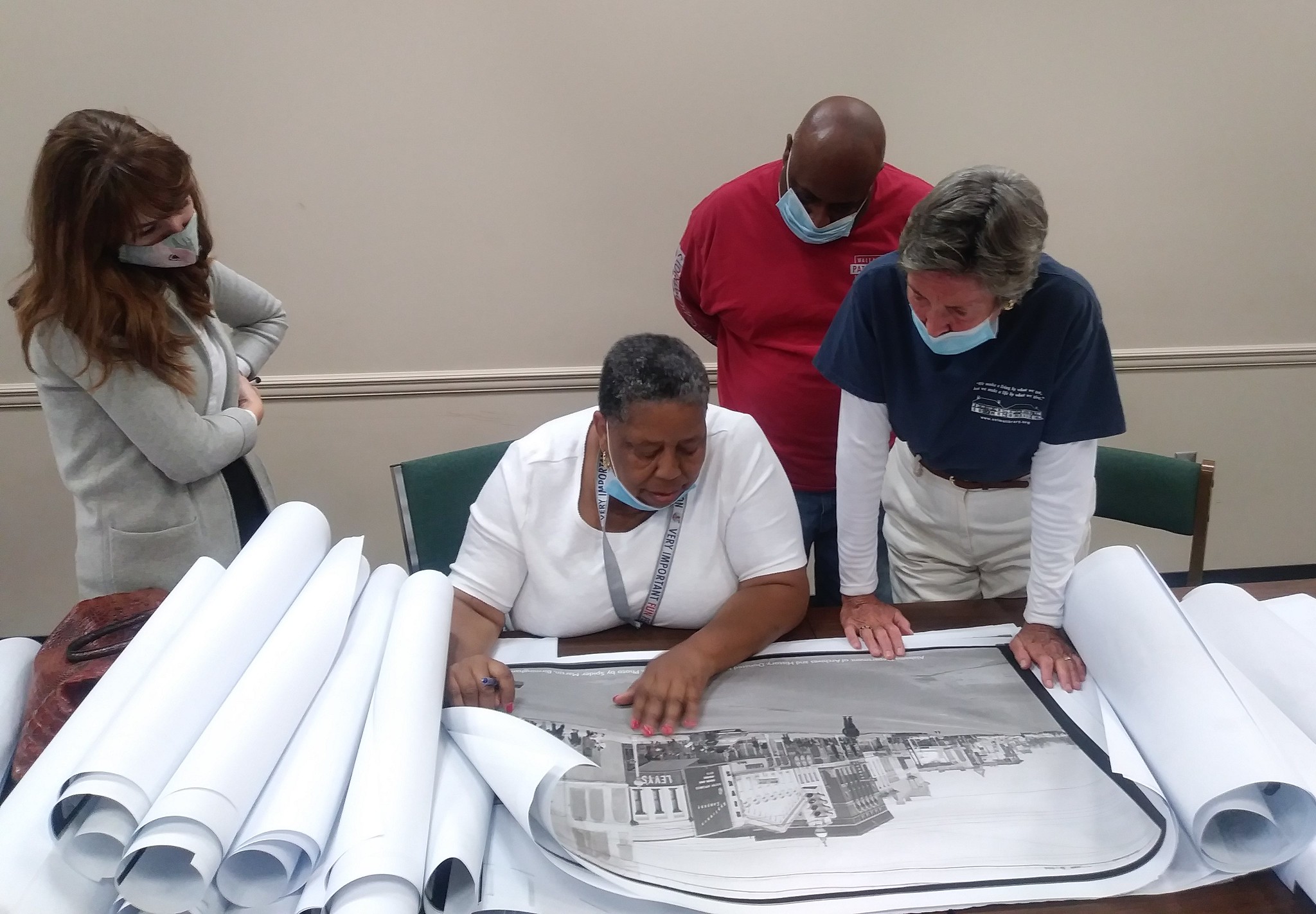 From left to right, Rachel Metcalf from the City of Selma, marcher JoAnn Bland, Selma Times reporter James Jones and Selma Public Library Director Becky Nichols recently met up to look at historic photos. Bland identified herself in one of the photos for the first time thanks to the project.
