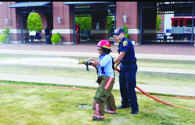 Firefighter teaches proper water hose technique