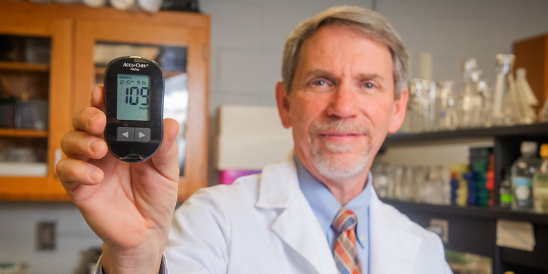 Robert Judd holds a blood glucose meter.