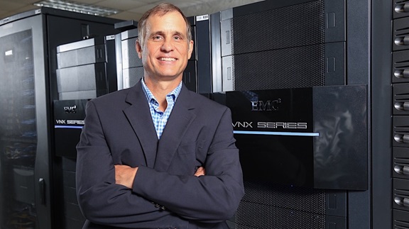 Jonathan Pettus in front of a wall of computer equipment