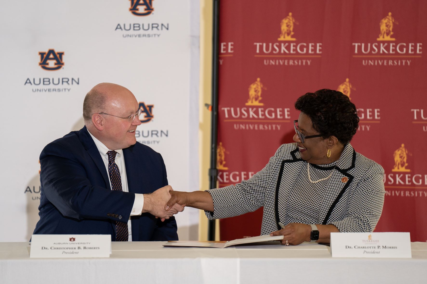 Auburn University President Christopher B. Roberts shakes hands with Tuskegee University President Charlotte P. Morris