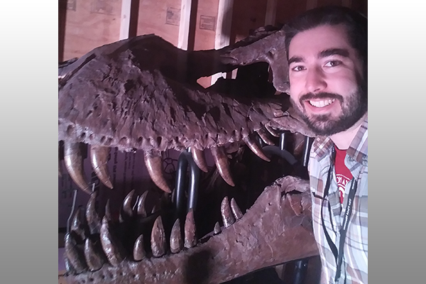 Thomas Cullen with Tyrannosaurus rex skull