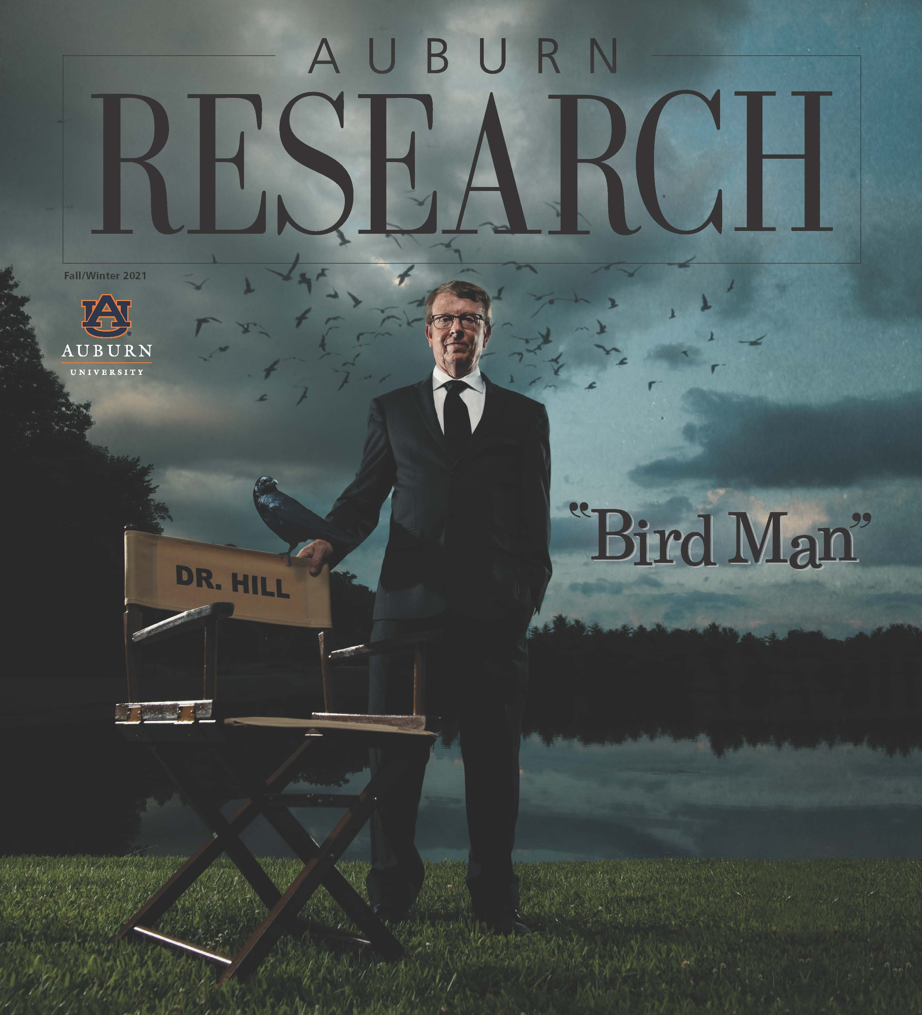 cover image of fall/winter 2021 Auburn Research magazine featuring Dr. Geoff Hill in suit and tie outdoors with director-style chair labeled "Dr. Hill" and multiple birds; text: "Bird Man" and Auburn University logo