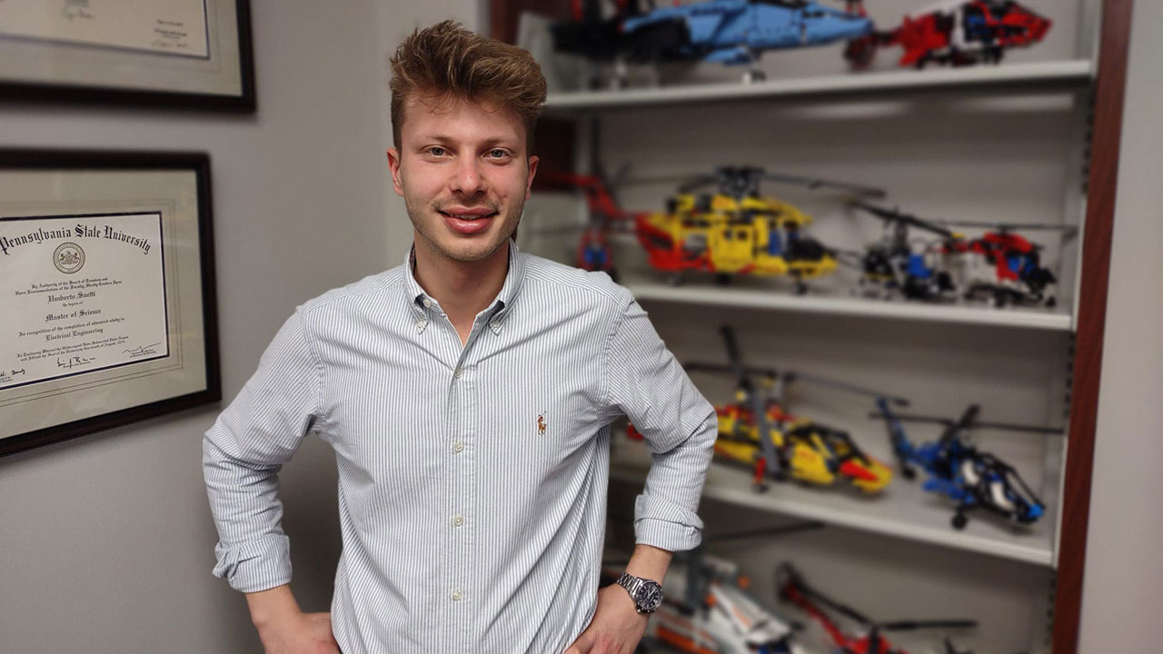 Umberto Saetti in office with model helicopters